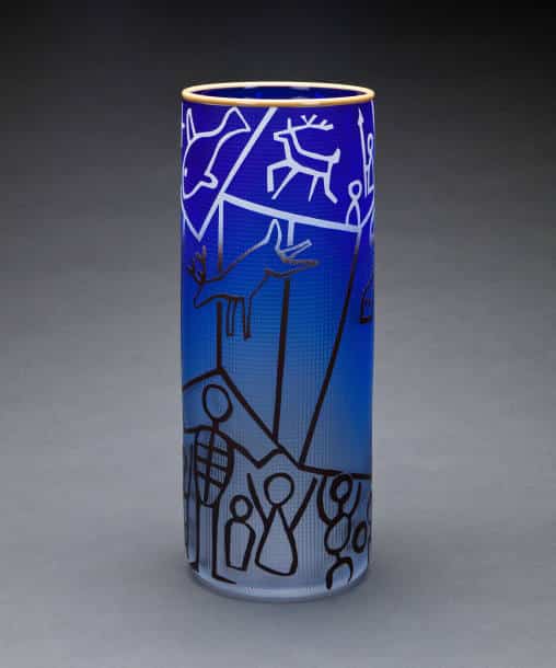 blue glass vase sketched with animal and human forms